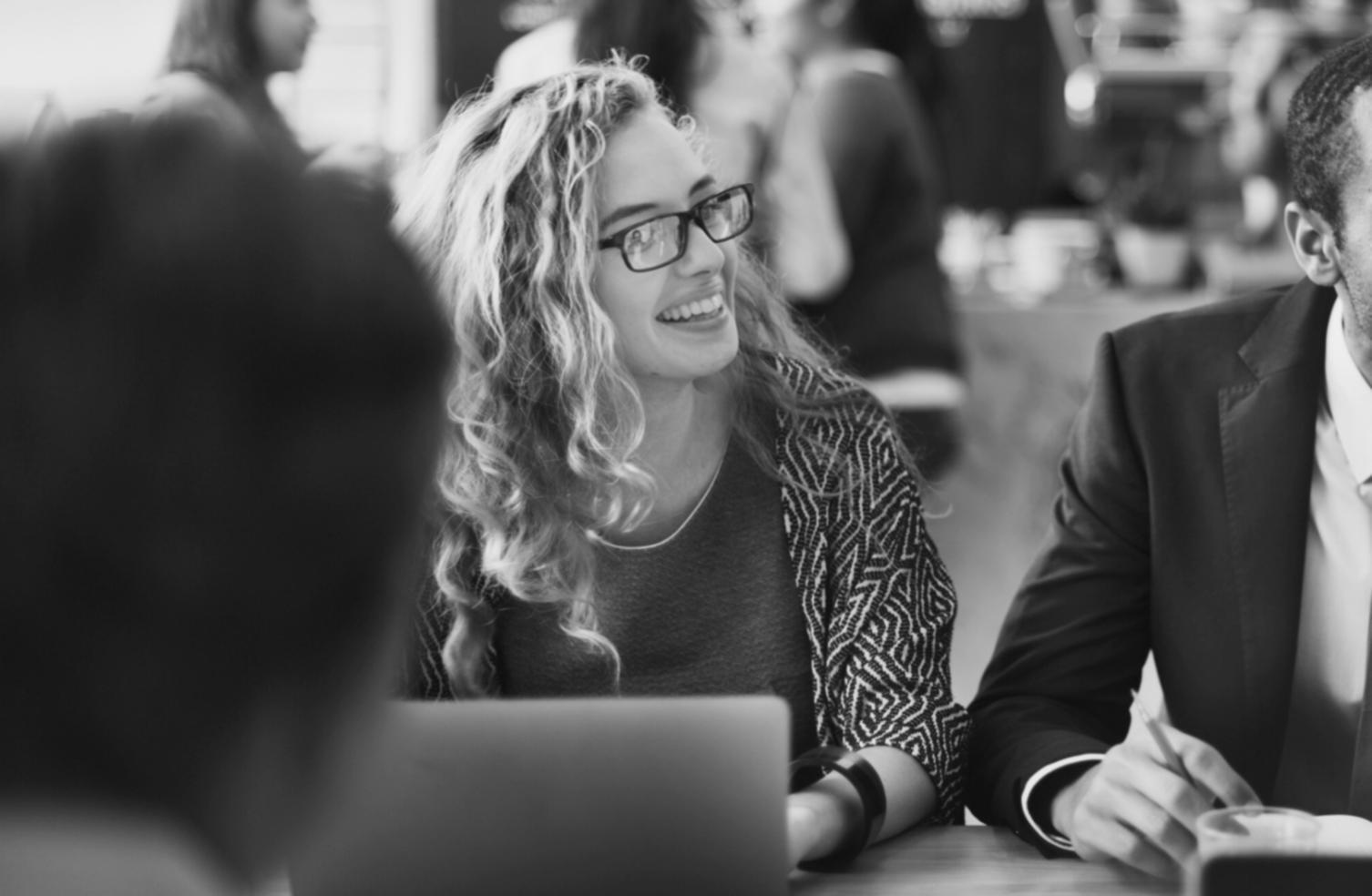 Organised financial planning workspace with notebooks and laptop